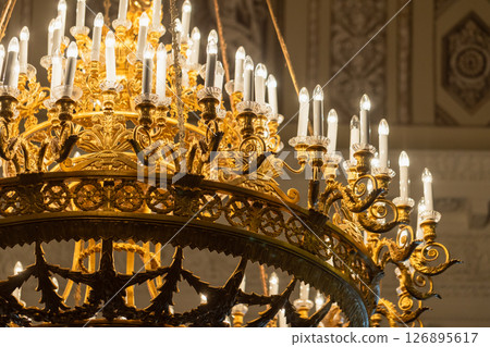 Detailed view of a luxurious golden chandelier Detailed view of a luxurious golden chandelier 126895617