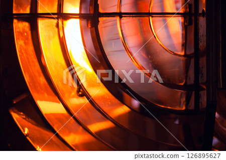 Warm-toned abstract close-up of metallic and glass structures 126895627