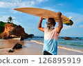 Senior man with surfboard walks on sandy beach. Elderly surfer embraces active lifestyle. Mature male enjoys ocean waves. Silver-haired sportsman finds joy in surfing. Healthy aging, vibrant life. 126895919