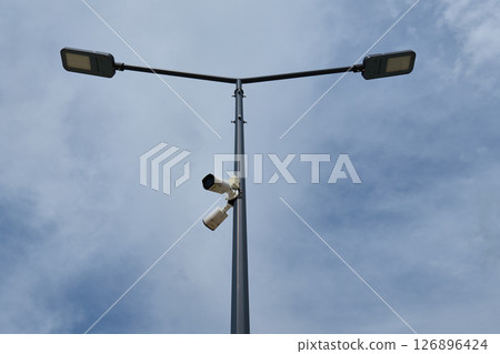 Street lamp featuring surveillance cameras on a cloudy day Street lamp featuring surveillance cameras on a cloudy day 126896424