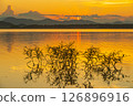 Landscape of mountains and lake at sunset and clouds reflected in the water. 126896916
