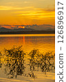 Landscape of mountains and lake at sunset and clouds reflected in the water. 126896917