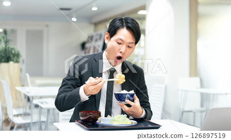 Male businessman eating a set meal 126897519