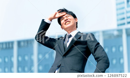 A male businessman going out on business under the hot summer sun 126897522