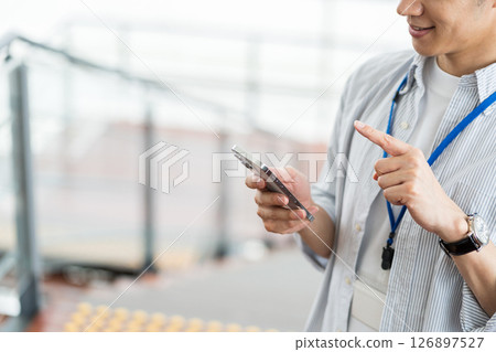 Businessmen (parts) who operate smartphones Businessmen (parts) who operate smartphones 126897527