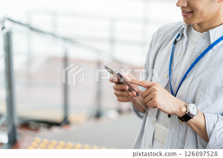 Businessmen (parts) who operate smartphones Businessmen (parts) who operate smartphones 126897528