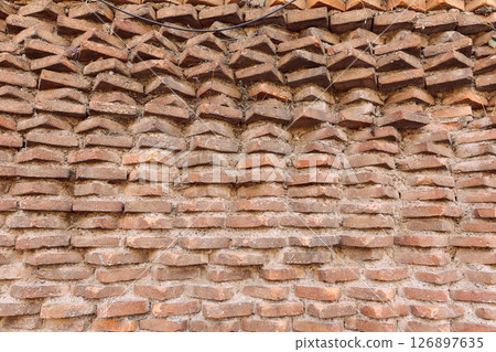 Wall of old red bricks with unusual masonry in Rome, Italy. High quality photo 126897635