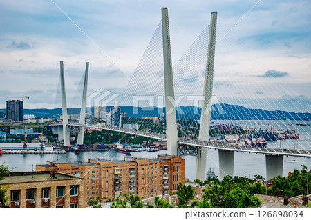 Cable stayed zolotoy rog bridge crossing over golden horn bay, dominating cityscape of vladivostok, russia, featuring modern architecture and maritime activity 126898034