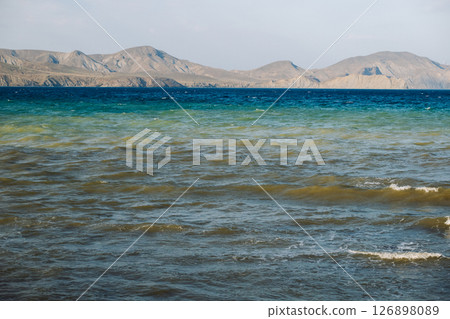 Seascape with mountains and waves forming colorful layers in Koktebel, Crimea Seascape with mountains and waves forming colorful layers in Koktebel, Crimea 126898089