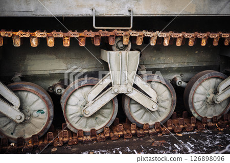 Rusty caterpillar track and wheels of a military tank 126898096
