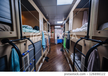 Capsule hotel room showing individual sleeping boxes offering privacy and comfort 126898122