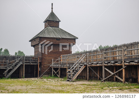 Ancient russian fortress with high wooden tower and palisade, evoking historical battles and medieval life Ancient russian fortress with high wooden tower and palisade, evoking historical battles and medieval life 126898137