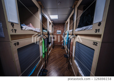 Compact sleeping pods inside a modern hostel providing comfortable accommodation for travelers 126898158