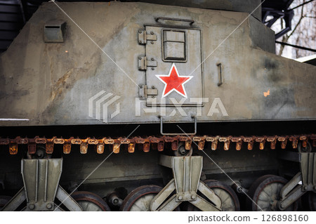 Close-up of rusty soviet tank showing red star and tracks 126898160