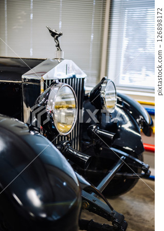 Close-up of Rolls-Royce front showing Spirit of Ecstasy, headlights and radiator grill 126898172