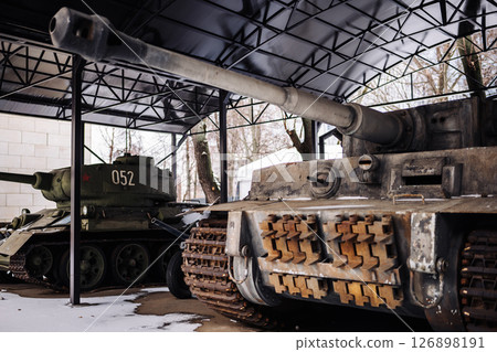 German Tiger I and Soviet T-34-85 tanks standing in museum hangar 126898191