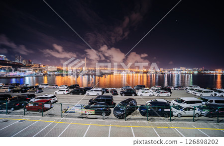 Night scene featuring illuminated golden horn bay bridge, parked vehicles, vladivostok cityscape Night scene featuring illuminated golden horn bay bridge, parked vehicles, vladivostok cityscape 126898202