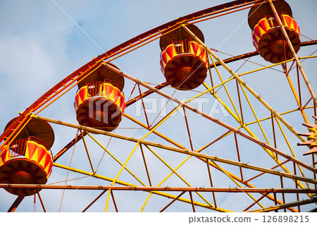 Ferris wheel with colorful cabins rotating in amusement park in Crimea 126898215