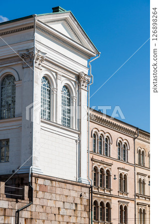 Ornate windows and stone foundation details define Helsinki's captivating architectural landscape. Ornate windows and stone foundation details define Helsinki's captivating architectural landscape. 126898264