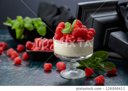 Mascarpone cream with fresh raspberries in a clear bowl. Mascarpone cream with fresh raspberries in a clear bowl. 126898411