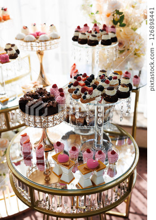 Delicious desserts decorating elegant candy bar table for wedding reception 126898441