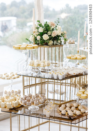 Delicious desserts decorating a wedding reception table Delicious desserts decorating a wedding reception table 126898483