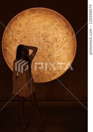 An Enigmatic Silhouette Set Against the Beautiful Radiance of a Full Moon at Night Time 126898675