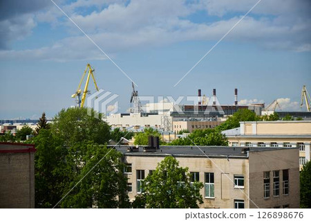 Urban Landscape featuring Cranes and Various Industrial Structures in a Modern Setting Urban Landscape featuring Cranes and Various Industrial Structures in a Modern Setting 126898676