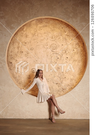 A Dreamy Model Gracefully Posing Against a Stunningly Large and Enchanting Moon Wall Art 126898706