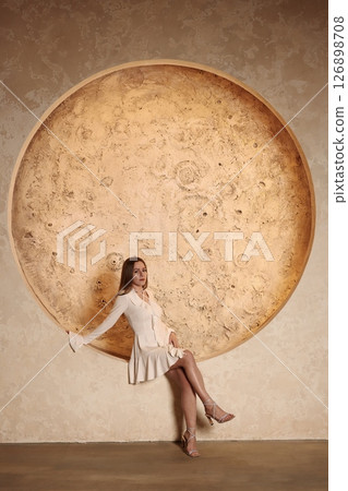 An Elegant Pose Set Against a Stylish Circular Structure in Artistic Presentation 126898708