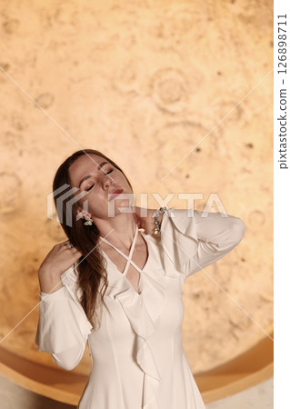 An Elegant Woman Posing with Serenity and Style in a Beautiful and Very Creative Way 126898711