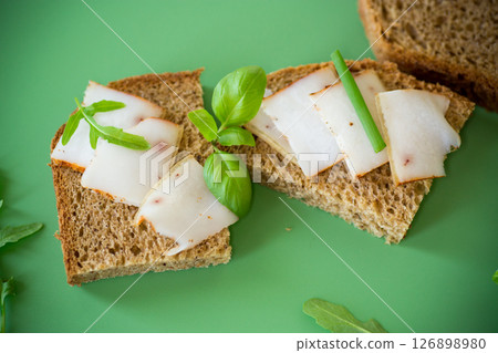 Sandwich with lard on rye bread and green onions on top 126898980