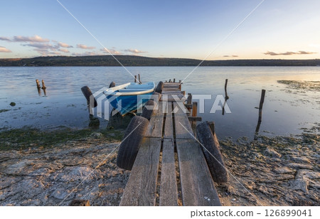 boats moored at beach against sky during sunset 126899041
