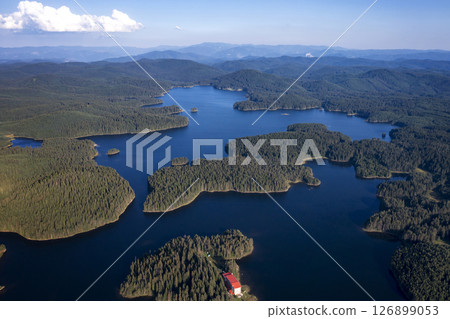 blue water and green forest. 126899053