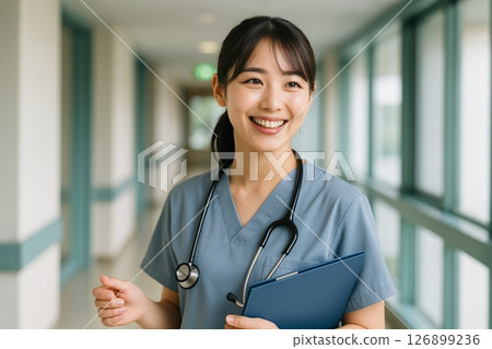 A young female nurse smiling after finishing her examination (inside the hospital, nurse uniform, stethoscope, Japanese) 126899236