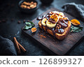 Enjoy a delightful breakfast with creative toasts topped with banana slices, nut butter, walnuts, and a sprinkle of cinnamon on a rustic wooden surface, perfect for a cozy morning meal 126899327