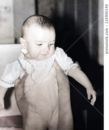 Vintage portrait of a little girl held by her mother's hands. Retro photo from 1994. 126900140