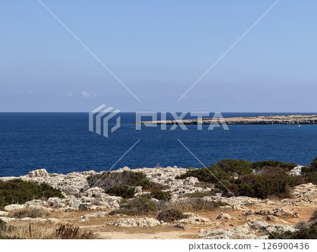 Picturesque beach, waves crashing on the sandy shore. Sea waves beat against the rocks. Cyprus Island, Mediterranean Sea. Picturesque beach, waves crashing on the sandy shore. Sea waves beat against the rocks. Cyprus Island, Mediterranean Sea. 126900436