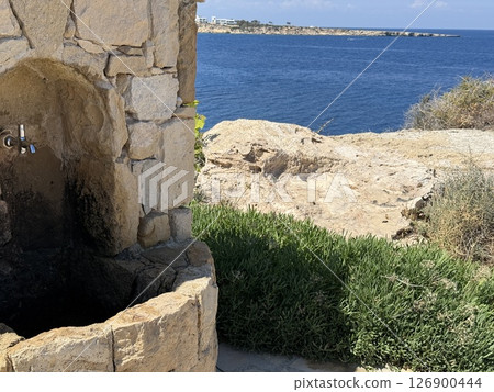 Picturesque beach, waves crashing on the sandy shore. Sea waves beat against the rocks. Cyprus Island, Mediterranean Sea. Picturesque beach, waves crashing on the sandy shore. Sea waves beat against the rocks. Cyprus Island, Mediterranean Sea. 126900444