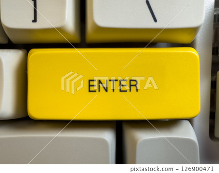 Large yellow Enter button on mechanical white keyboard for programmers with gray shades and red switches, flay lay, copy space Large yellow Enter button on mechanical white keyboard for programmers with gray shades and red switches, flay lay, copy space 126900471