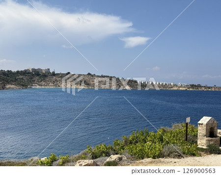 Picturesque beach, waves crashing on the sandy shore. Sea waves beat against the rocks. Cyprus Island, Mediterranean Sea. 126900563