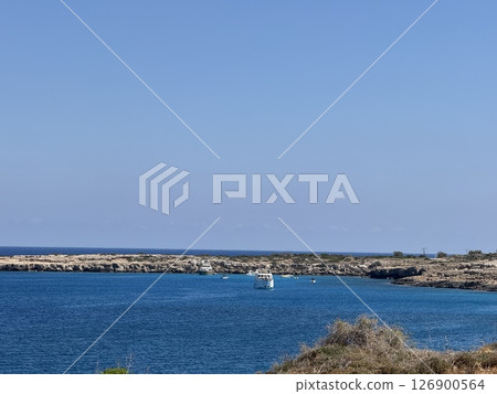 Picturesque beach, waves crashing on the sandy shore. Sea waves beat against the rocks. Cyprus Island, Mediterranean Sea. Picturesque beach, waves crashing on the sandy shore. Sea waves beat against the rocks. Cyprus Island, Mediterranean Sea. 126900564