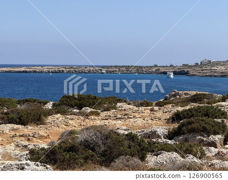 Picturesque beach, waves crashing on the sandy shore. Sea waves beat against the rocks. Cyprus Island, Mediterranean Sea. Picturesque beach, waves crashing on the sandy shore. Sea waves beat against the rocks. Cyprus Island, Mediterranean Sea. 126900565