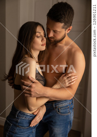 Man embracing gorgeous woman in house couple showing passionate love Man embracing gorgeous woman in house couple showing passionate love 126901211