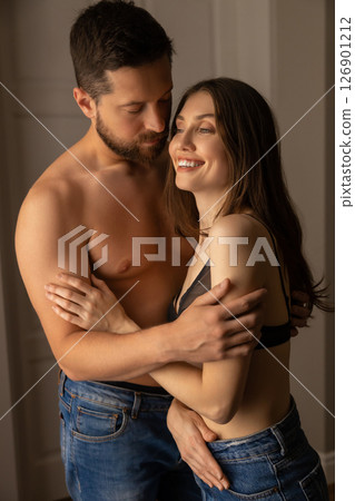 Woman cuddling her attractive partner in house lovers touching tenderly Woman cuddling her attractive partner in house lovers touching tenderly 126901212