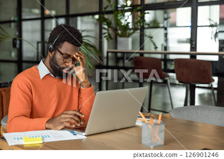 African american entrepreneur looking tired after hours of overtime 126901246