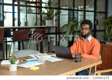 African american businessman sitting at the laptop in the office 126901275
