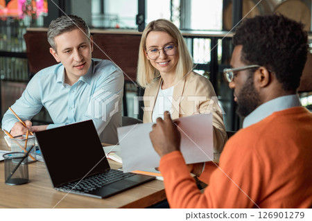 Group of business consultants looking involved while discussing a new case 126901279
