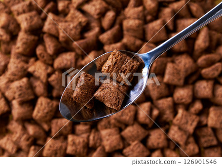 chocolate corn pads in a metal spoon of above chocolate pads as background. Copy space for text. chocolate corn pads in a metal spoon of above chocolate pads as background. Copy space for text. 126901546