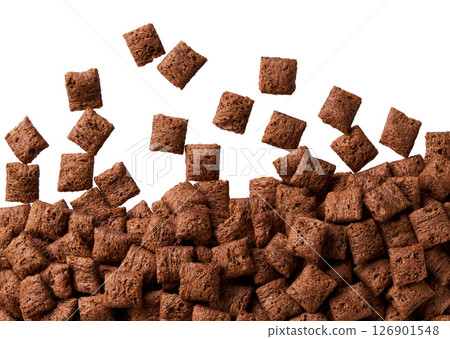chocolate corn pads scattered in a white background, top view. chocolate corn pads scattered in a white background, top view. 126901548